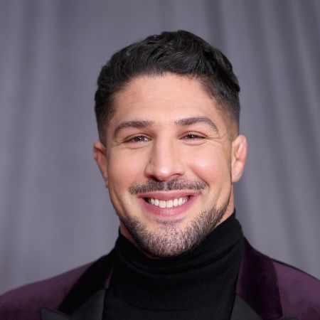 He is looking handsome and smiling in this picture.